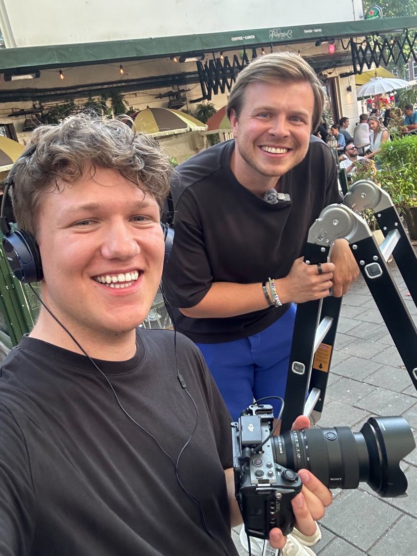 Gabriel with camera and headphones on a street shoot with the show's host